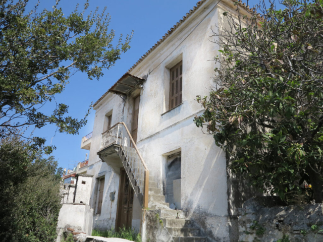 The original facade of the house. Two coats of plaster now falling off and beyond patching